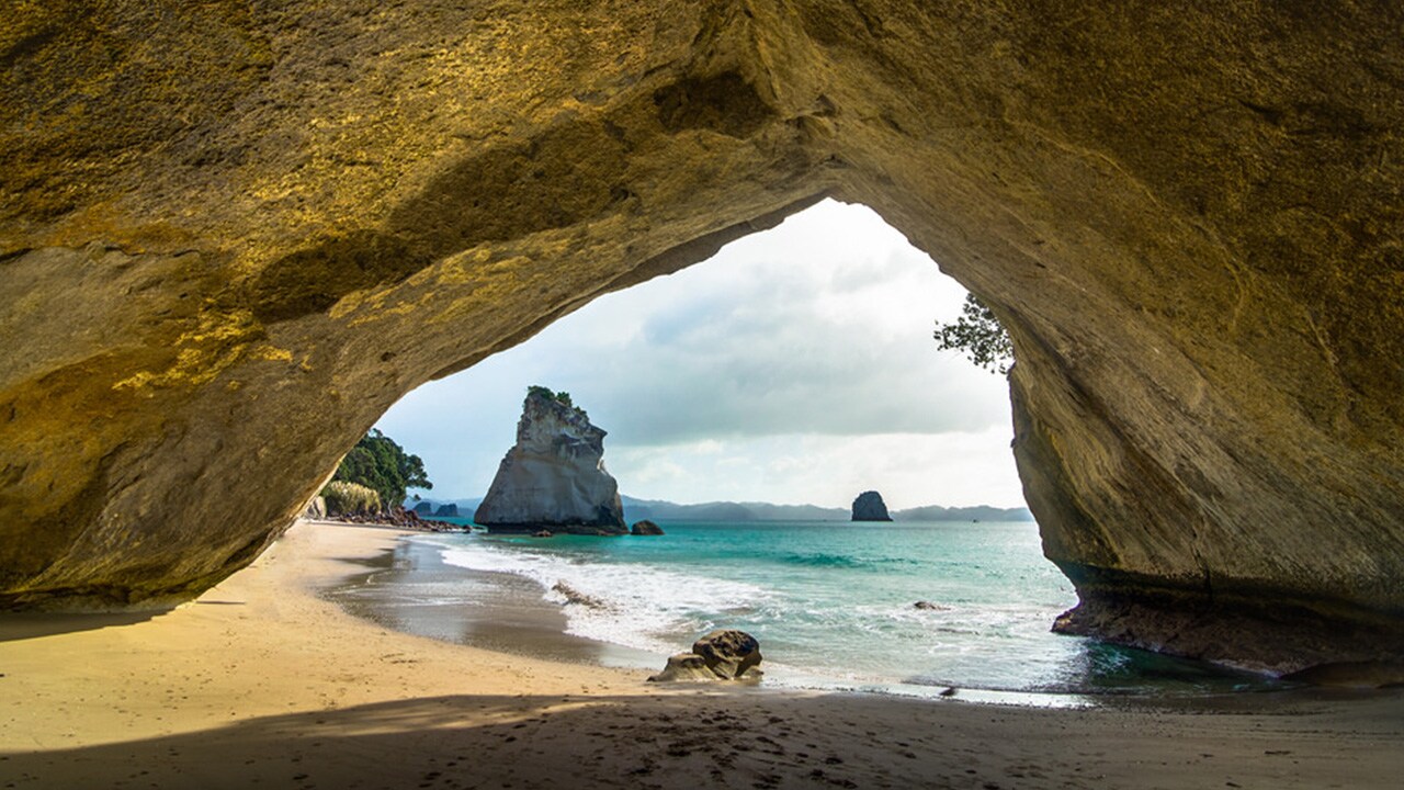 Looking through the coves onto an Auckland beach on a summer day.