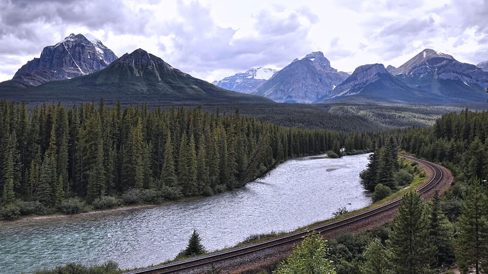 River, railway and Rocky Mountains in Banff National Park, Alberta