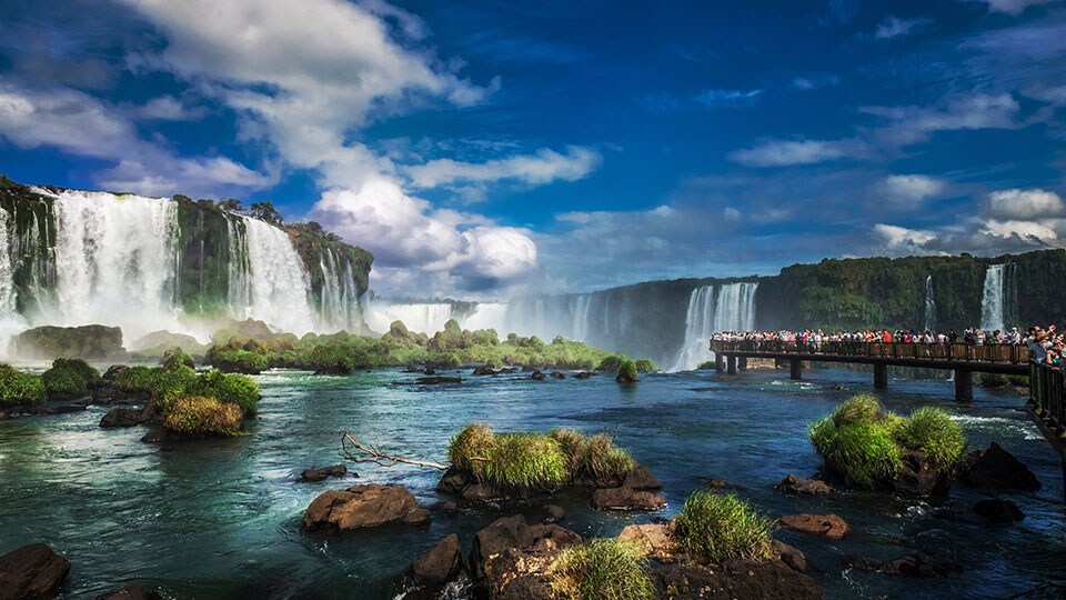 Tourists at Iguazu Falls, one of the world's great natural wonders, near the border of Argentina and Brazil.